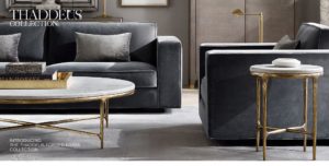 Gray sofa and chair with gold and white accent tables